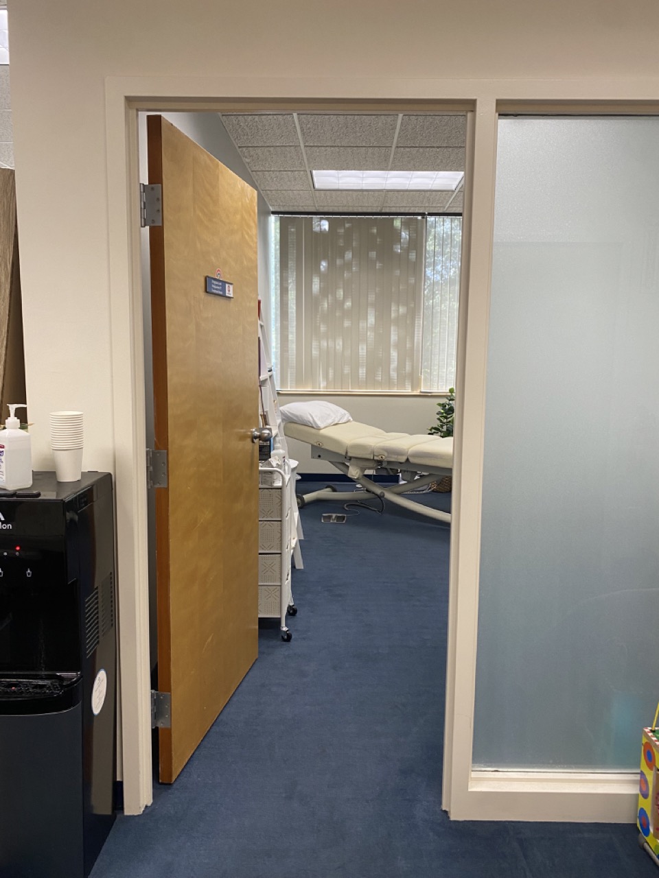 An open door to a pelvic floor therapy treatment room, welcoming the viewer into Pregnancy and Postpartum PT's comfortable space.